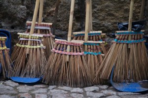 Colorful brooms on a stone pavement
